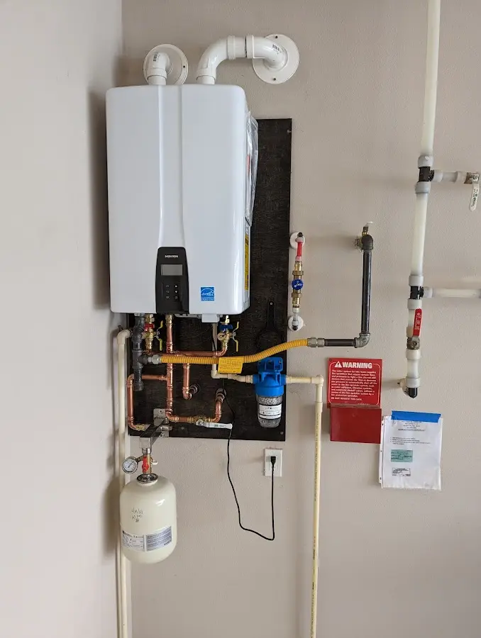 Professional plumber installing copper piping in a Hidden Meadows home